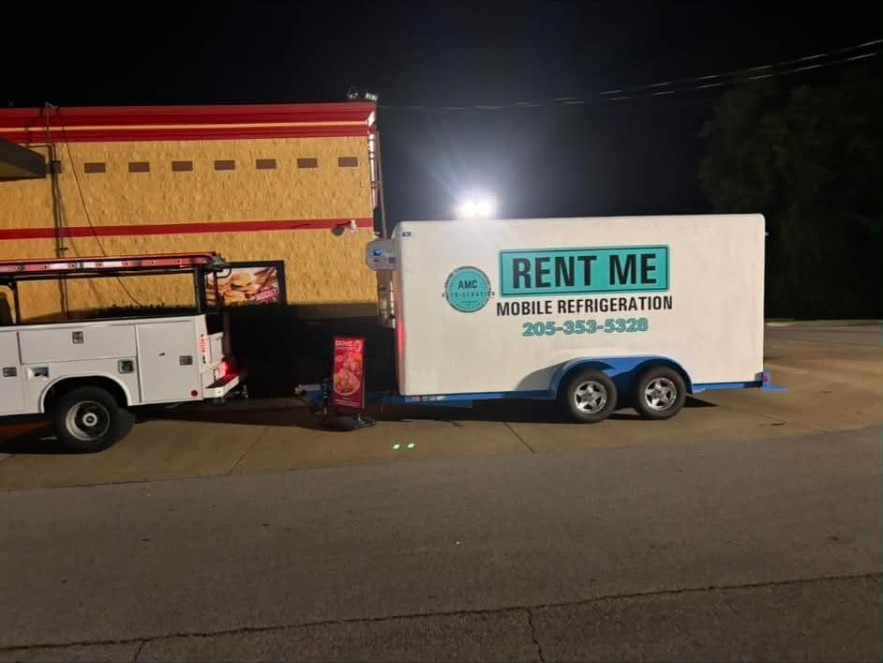 Mobile refrigeration trailer running overnight beside a restaurant